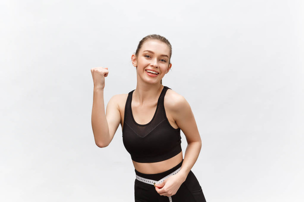 Image of a beautiful strong happy cheerful young sports woman posing isolated on grey background. - Fotó, kép