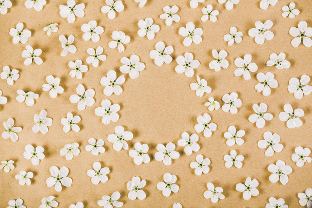 Cadre floral composé de fleurs blanches de printemps sur fond de papier brun. Pose plate. Vue du dessus
. - Photo, image