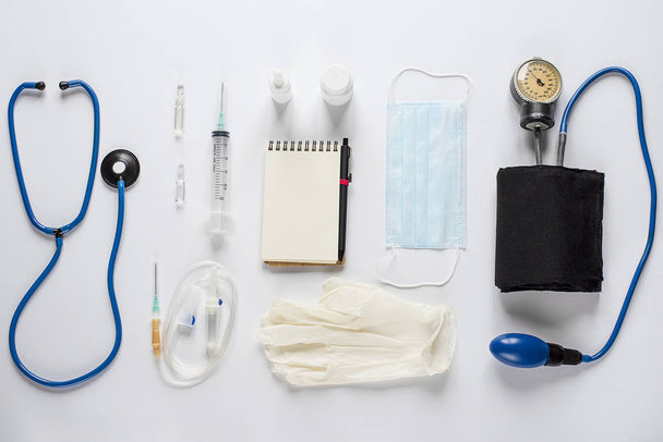 Various medical equipment and Notepad on white background - Valokuva, kuva