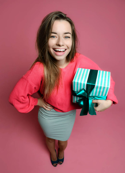 Beautiful woman with shopping presents gift box for happy valentines day on pink  - Photo, image