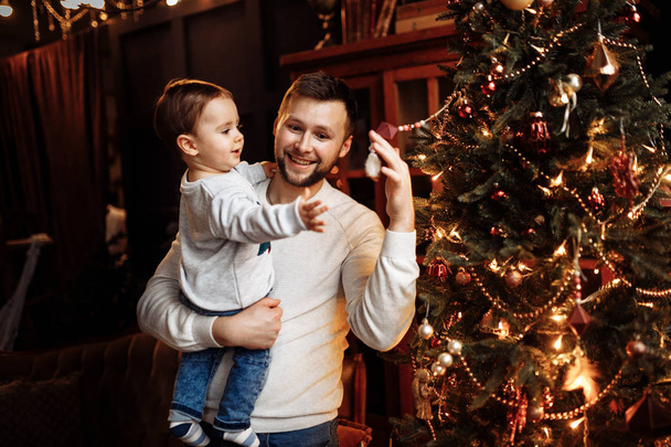 Happy young father   with son on Christmas  - Фото, изображение