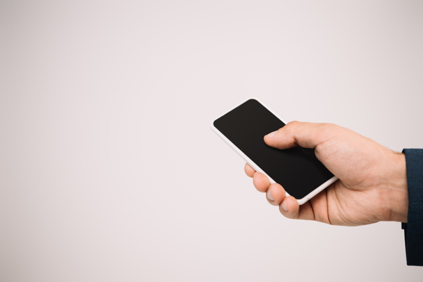 cropped view of businessman using smartphone isolated on grey - Photo, Image