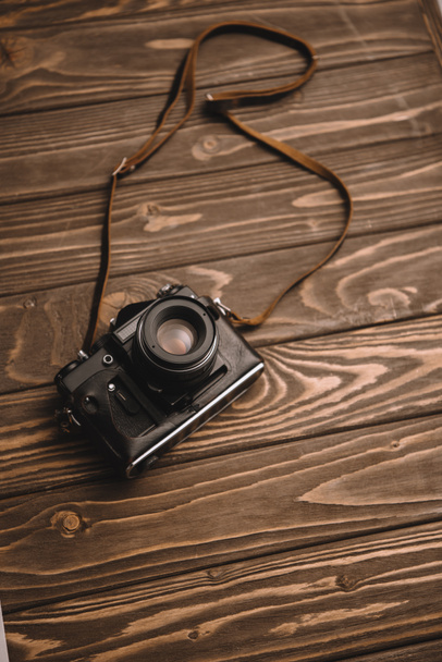 retro photo camera on wooden table with copy space - Photo, Image