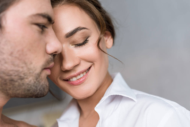 close up of attractive woman smiling with closed eyes near boyfriend  - Фото, зображення