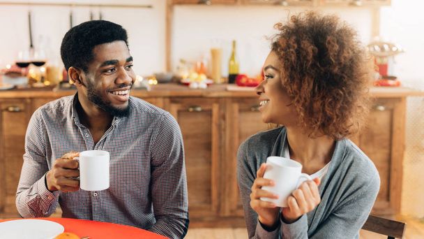 Couple enjoying cup of coffee together in kitchen - Photo, Image