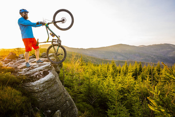 Mountain biker riding on bike in spring mountains forest landscape. Man cycling MTB enduro flow trail track. Outdoor sport activity. - Photo, Image