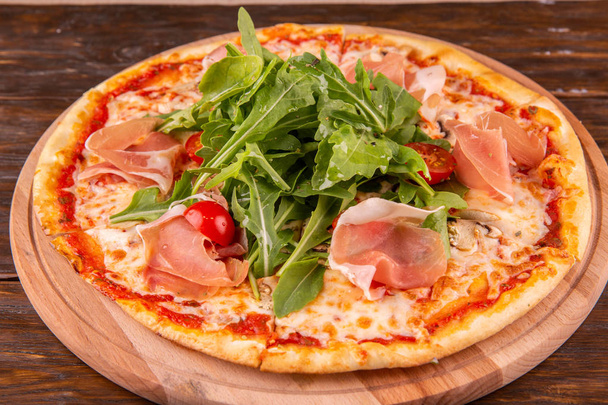 Parma on champignons and arugula tomatoes pizza - Фото, изображение
