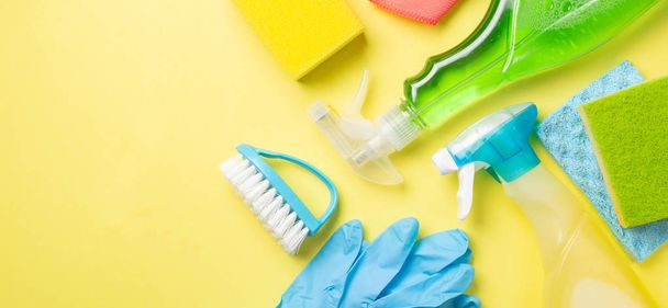 Cleaning concept - cleaning supplies on pastel yellow background - Φωτογραφία, εικόνα
