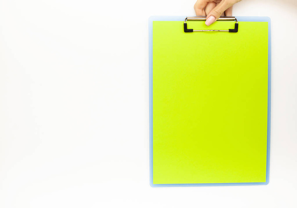 Blank Folder with Green Paper. Hand that Holding Folder and Pan Handle on White Background. Copyspace. Place for Text - Photo, Image