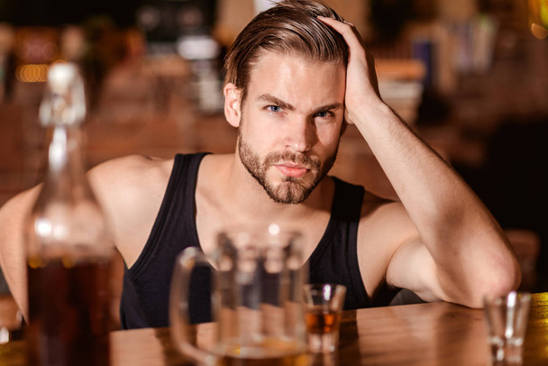 Enjoy the drinks, but not too much. Alcohol addiction and bad habit. Alcoholic man drinking at bar counter. Man drink strong alcoholic drink and beer in pub. Alcohol addict with short alcohol drink - Фото, зображення