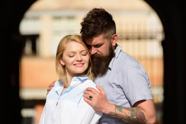 Two hearts full of love. Sensual woman and man enjoy romantic date. Bearded man hug sexy girl. Couple in love. Loving couple of woman and hipster dating outdoor. Feeling love and romance - Φωτογραφία, εικόνα