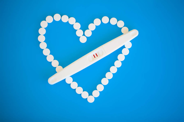 Pregnancy test. The result is positive with two strips. Treatment of infertility with pills, help in conceiving a child. Tablets from pregnancy do not work, contraception - Photo, Image