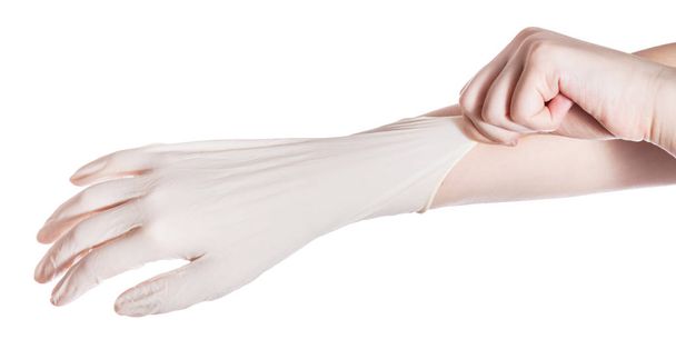 por encima de la vista de la mano femenina lleva guante de látex en otra mano aislada sobre fondo blanco
 - Foto, Imagen