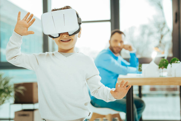 Smart boy smiling while exploring virtual reality - Fotoğraf, Görsel