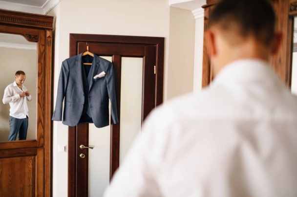 Dressing groom and preparing for ceremony on background  - Photo, image