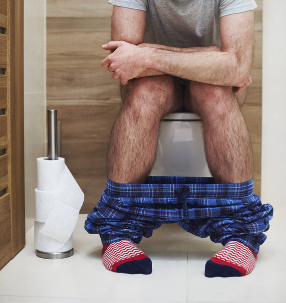 Низька частина чоловіка дефекація в туалеті
 - Фото, зображення