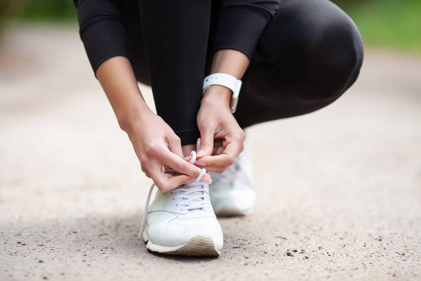 Sneakers Problem. Female Runner Tying Her Shoes Preparing For a jog - Photo, Image