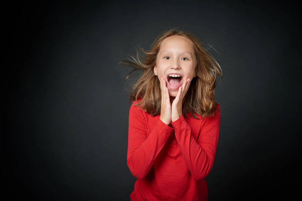 Excited surprised preteen girl screaming of joy - Фото, изображение