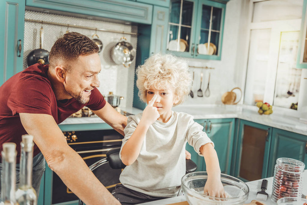 Bearded dark-haired father cooking with his cute preschool son - Foto, Imagen