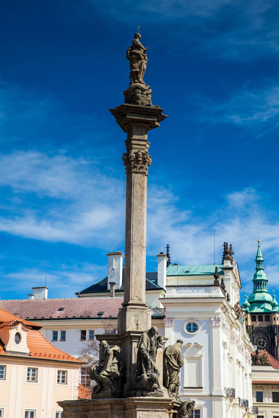 Plague column of Virgin Mary built on 1715 at Hradcany Square on the lesser quarter of Prague in a beautiful early spring day - Photo, Image