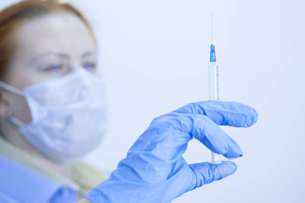 Concept doctor with a vaccine syringe. Protection against bacter - Foto, afbeelding