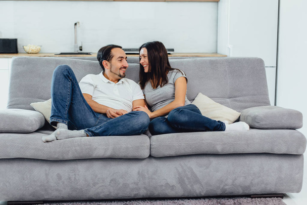 woman and man on the couch - Фото, изображение