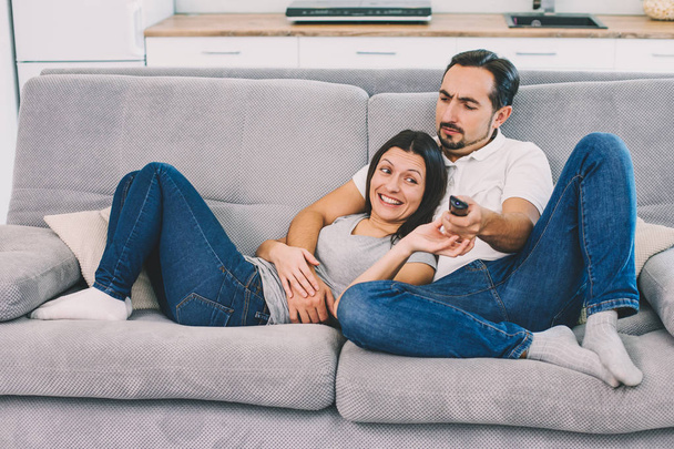 Husband and wife sitting on a sofa - Zdjęcie, obraz