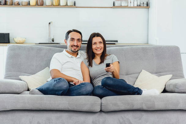 Husband and wife sitting on a sofa - 写真・画像