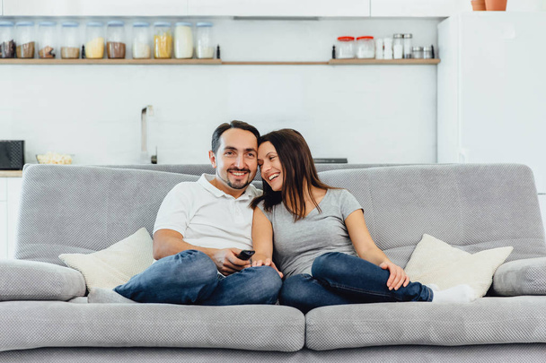 A woman and a man watch TV - Foto, Imagen