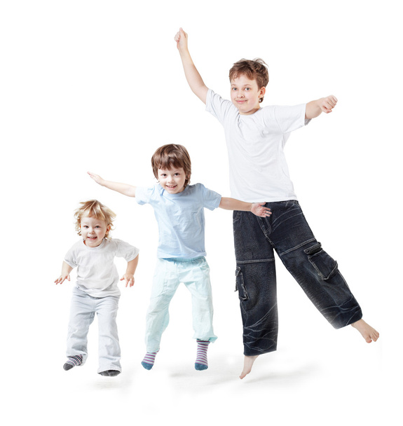 three children jump on white - Foto, afbeelding