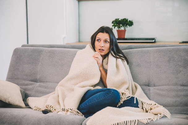Woman looks TV on the couch - Photo, image