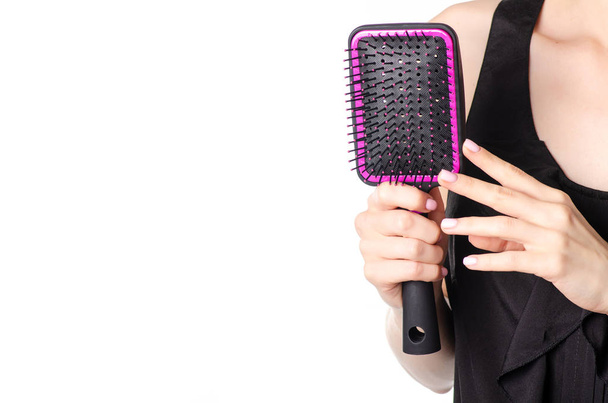 Woman holding a hairdryer and comb - Fotó, kép
