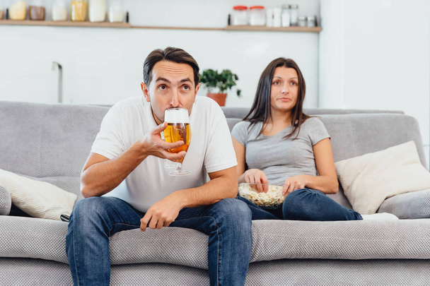 Husband and woman sitting on the couch - Valokuva, kuva