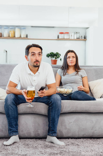 Husband and woman sitting on the couch - Valokuva, kuva