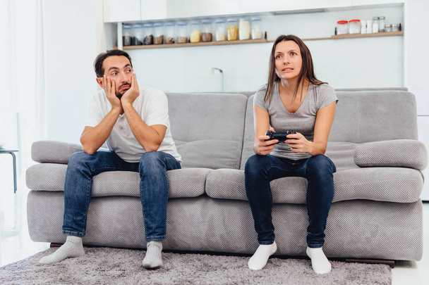 The wife plays the game while the man just sits - Photo, Image