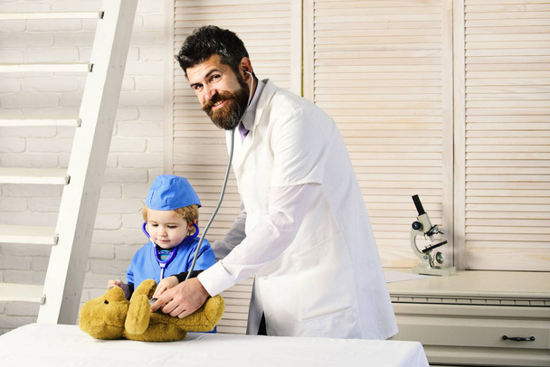 Father and kid with happy faces play doctor - Photo, Image