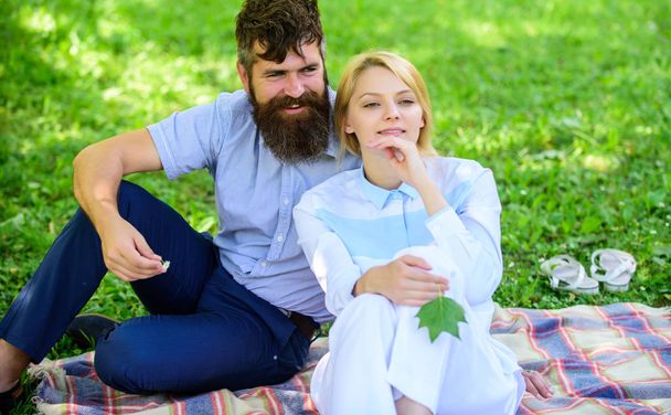 Pure nature. Couple with green leaf relax natural environment. Couple bearded man and woman enjoy nature while sit on green grass meadow. Nature beauty concept. Woman enjoy relax nature background - Photo, image