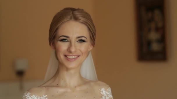 Portrait of a bride in a wedding dress. The bride dresses in the hotel. Video. happy bride - Footage, Video