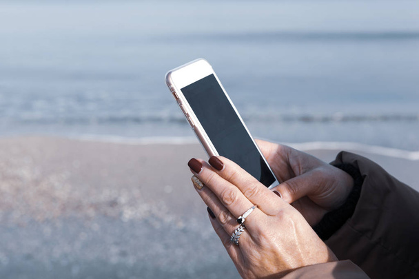 Bella donna che utilizza Smart Phone su una spiaggia - Foto, immagini