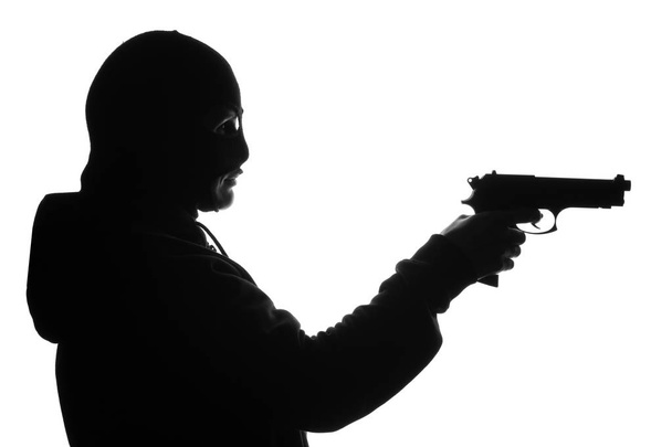 Силуэт бандита с пистолетом на белом фоне
 - Фото, изображение