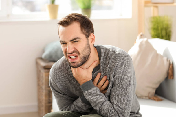 Young man having asthma attack at home - Valokuva, kuva