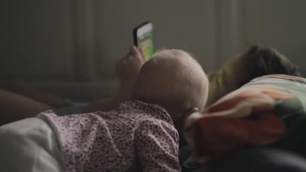 Baby girl is attracted with brothers tablet computer - Záběry, video