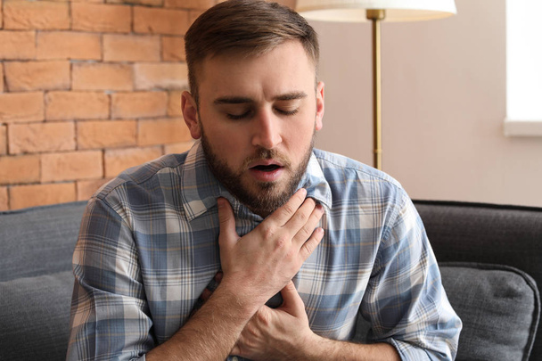 Young man having asthma attack at home - Photo, Image