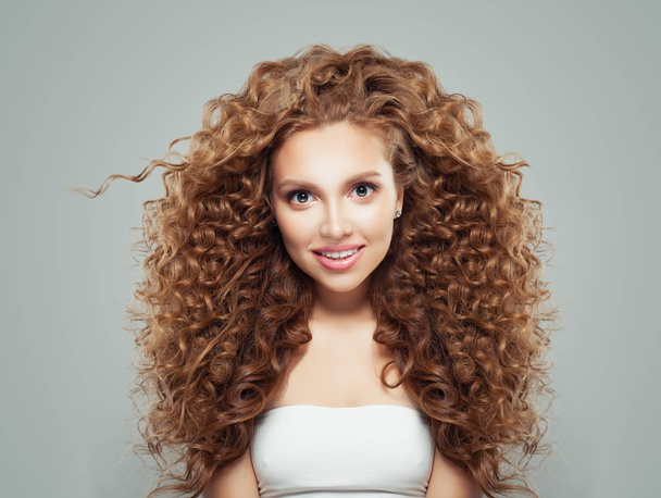 Perfect redhead girl with long healthy curly hair. Hair care concept - Photo, Image