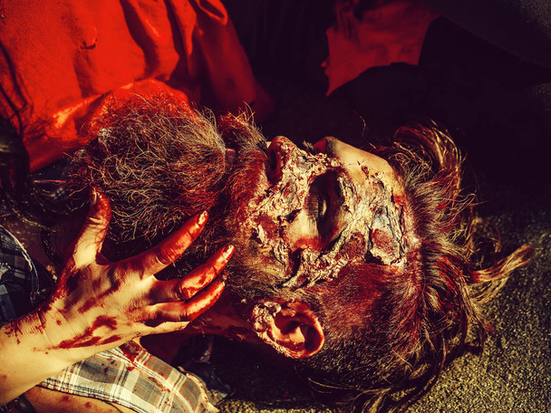 Bloody hands hold zombie man - Fotó, kép