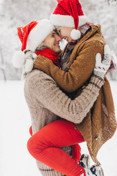 couple in love lie in the snow, laugh and enjoy - Фото, изображение