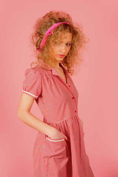 Pinup girl vintage with curly hair. Pretty woman pinup style in retro fashion dress. Curly is beautiful - 写真・画像