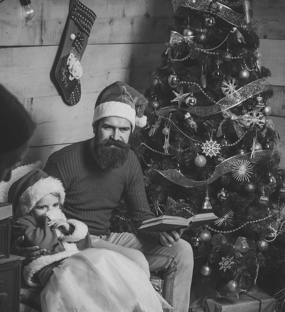 Christmas happy child and father read book. - Zdjęcie, obraz