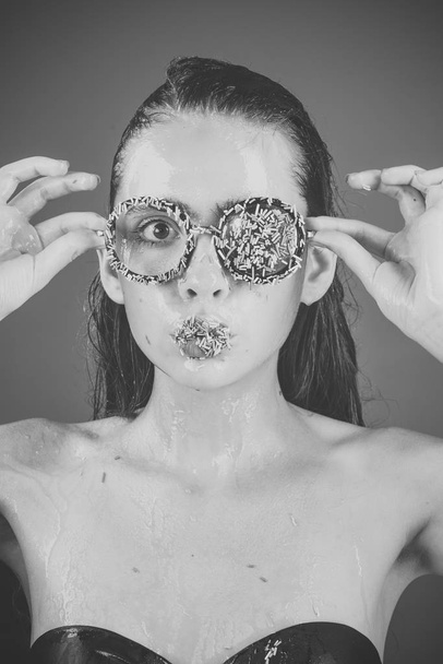 Makeup of sugar candy kiss on lips. Beauty and fashion model of glamour girl. Young woman with sprinkles makeup. Sprinkles lipstick and glasses on girl, valentines day. Diet and sweet dessert, easter. - Photo, image