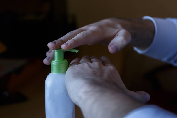 Smearing moisturizer on damaged hands of a cream jar with dispenser - Photo, Image